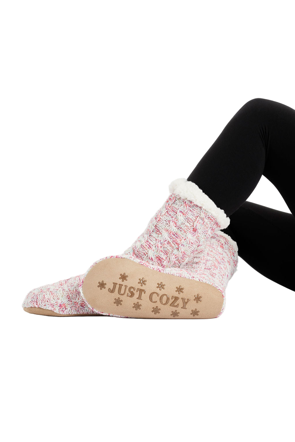 A pair of pink and white cozy slipper socks with a knitted shell and sherpa lining, featuring the text 'COZY' on the top.