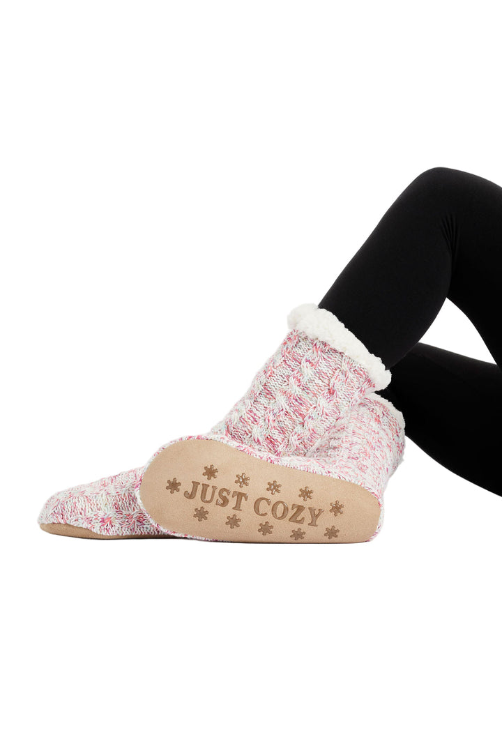 A pair of pink and white cozy slipper socks with a knitted shell and sherpa lining, featuring the text 'COZY' on the top.